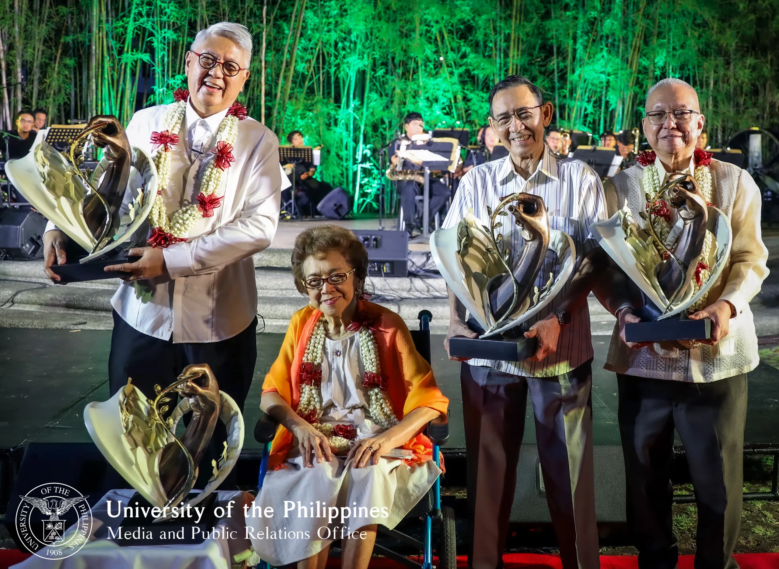 National Artists Fides Cuyugan-Asensio, Ryan Cayabyab, Gémino H. Abad, and Ricky Lee hold token mementos designed by Committee on Culture and the Arts Chair Toym Imao, taken during “Tanghal Tertulia” held at the amphitheater of the UP Executive House in UP Diliman, March 8, 2025. Photo by Jonathan Madrid, UP MPRO.